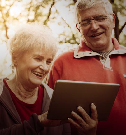 Happy senior couple viewing a tablet